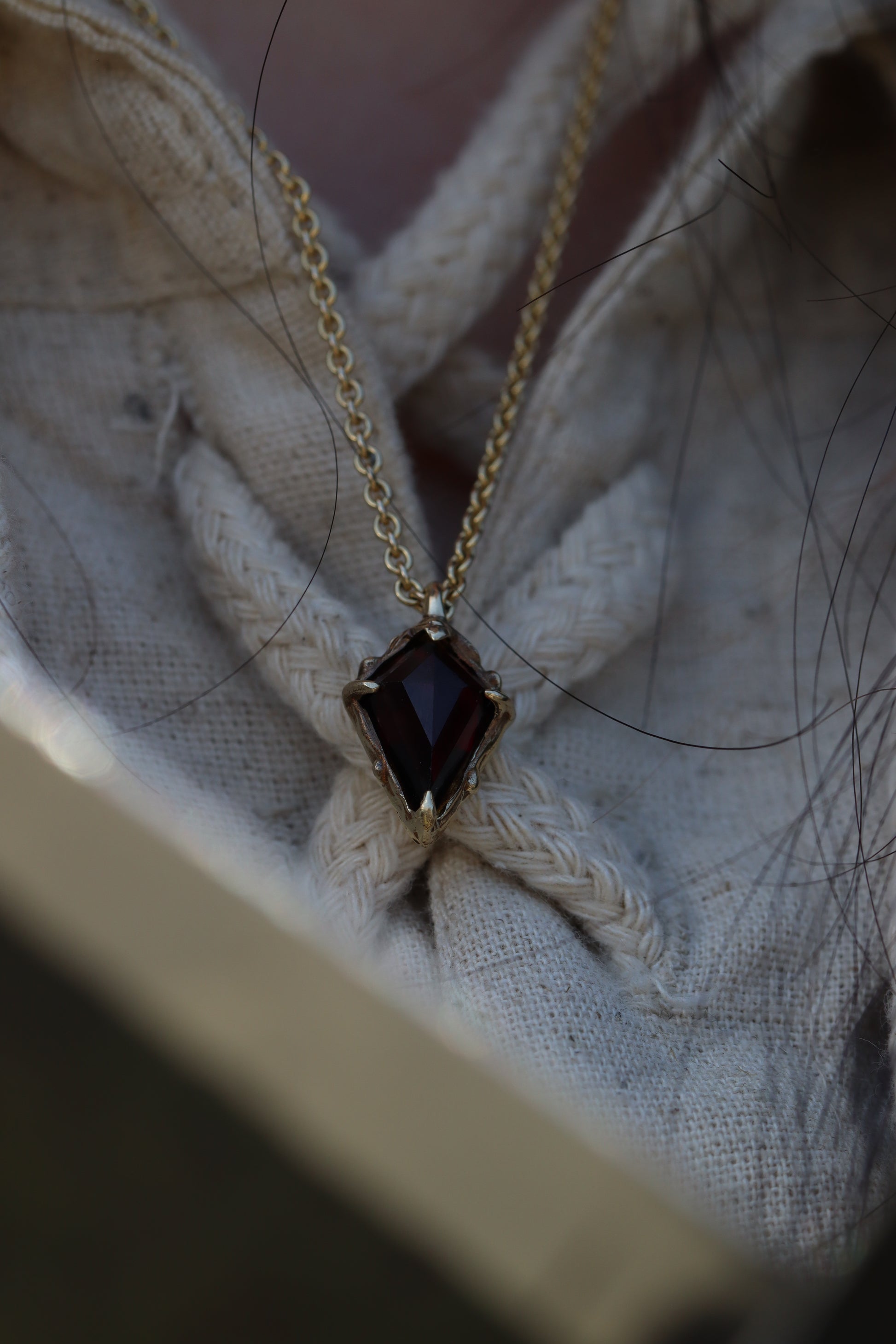 The Amulet of King, in 10K gold, worn by a model