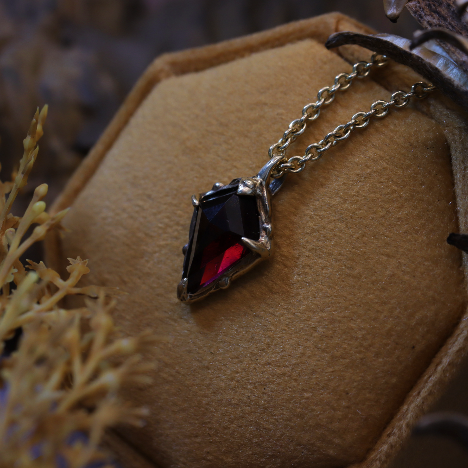 The Amulet of King, in 10K gold, resting in the leafs