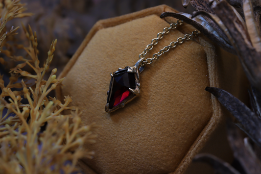 The Amulet of King, in 10K gold, resting in the leafs