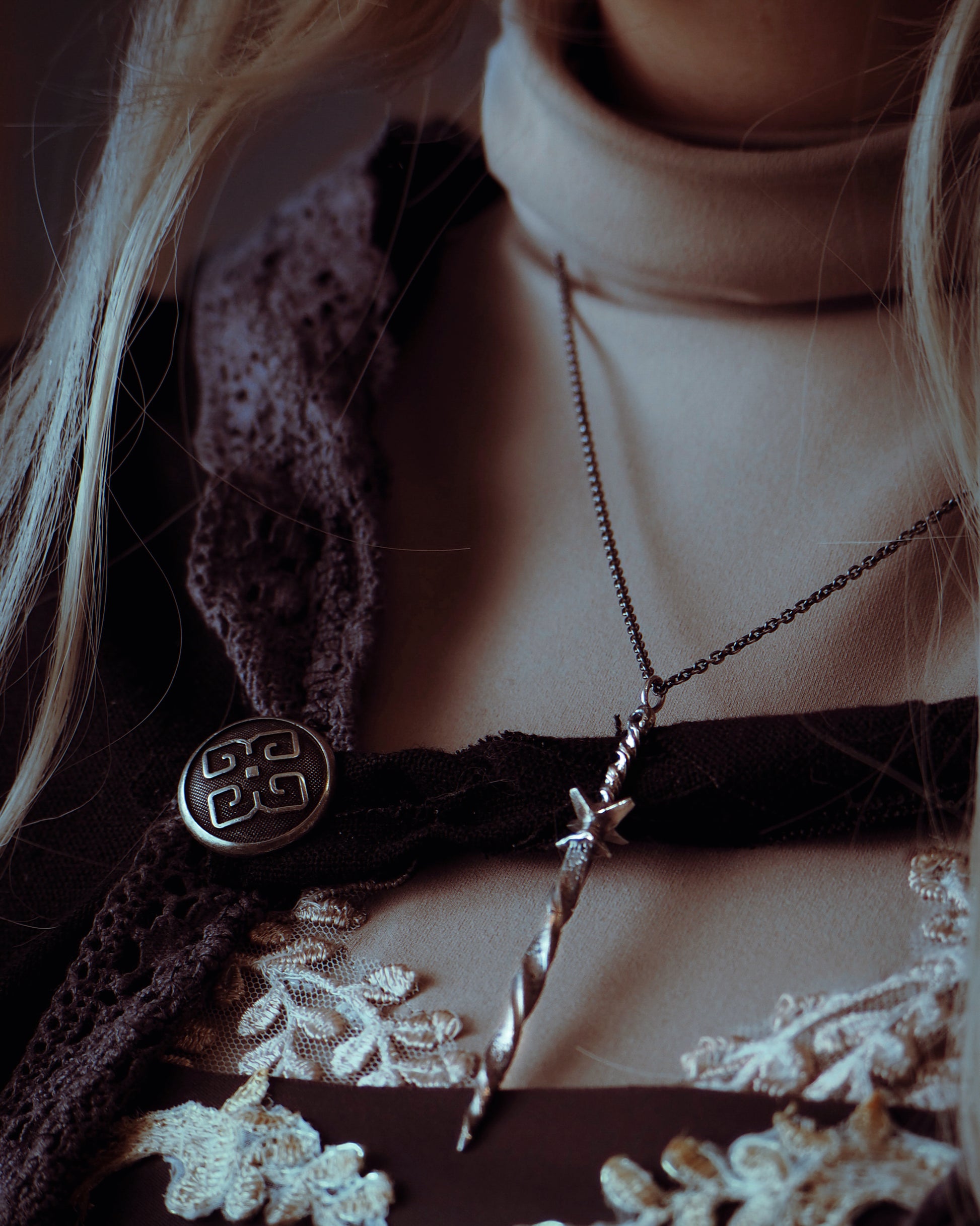 Close-up of a person wearing a necklace 